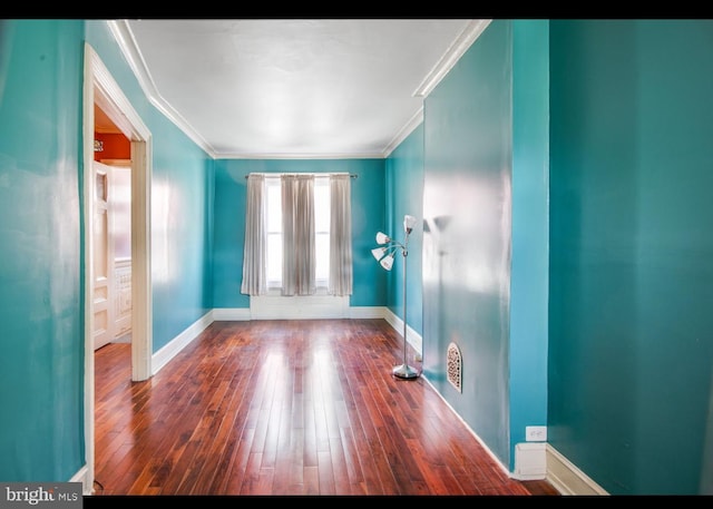 interior space featuring ornamental molding and dark hardwood / wood-style flooring