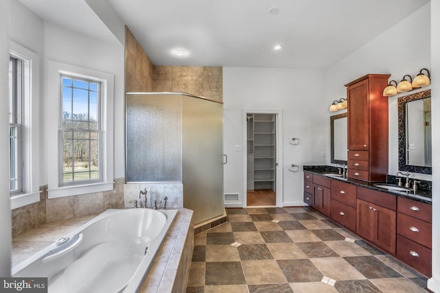 bathroom with dual sinks, tile flooring, large vanity, and independent shower and bath