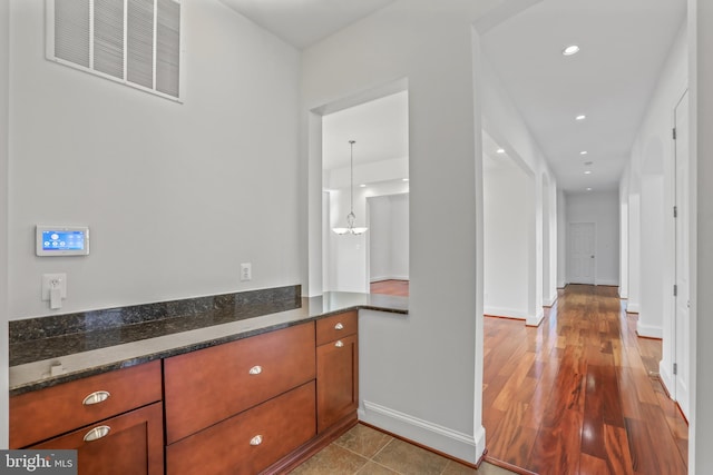 interior space with vanity and hardwood / wood-style flooring