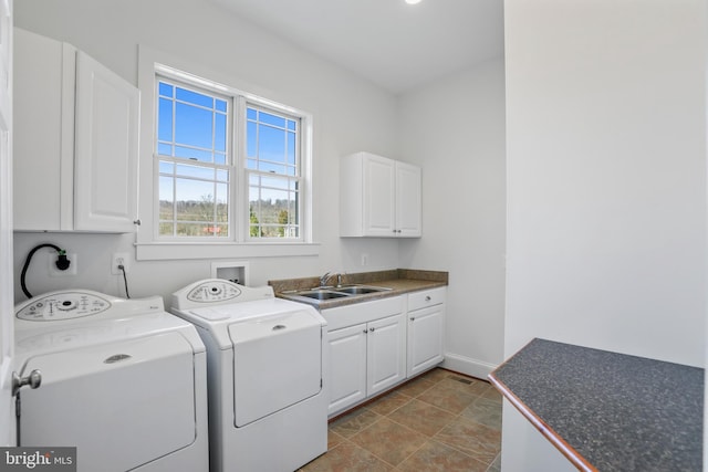 clothes washing area featuring tile flooring, sink, hookup for an electric dryer, cabinets, and washer and clothes dryer