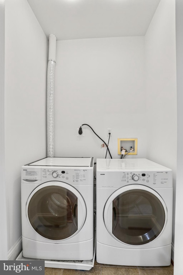 laundry room featuring electric dryer hookup, washing machine and dryer, tile flooring, and hookup for a washing machine