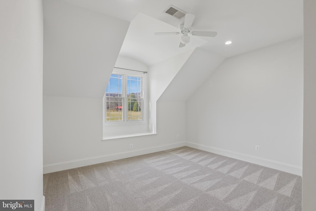 bonus room with light carpet, vaulted ceiling, and ceiling fan