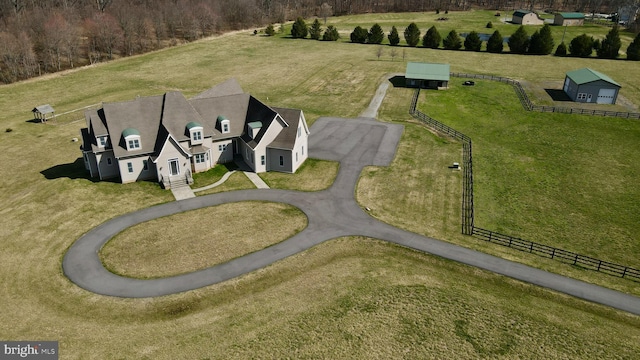 birds eye view of property with a rural view