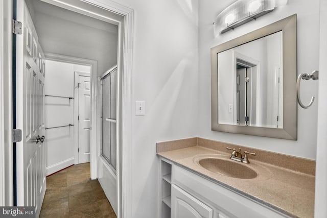 bathroom featuring combined bath / shower with glass door, tile floors, and vanity with extensive cabinet space