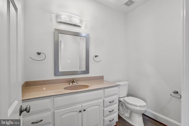 bathroom featuring tile floors, toilet, and vanity