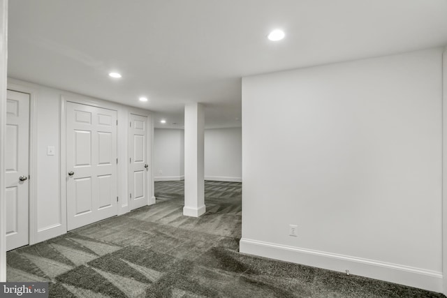 basement featuring dark carpet