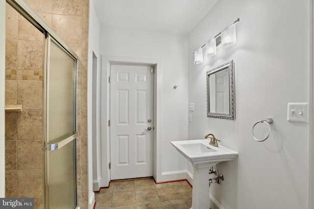 bathroom featuring tile flooring and an enclosed shower