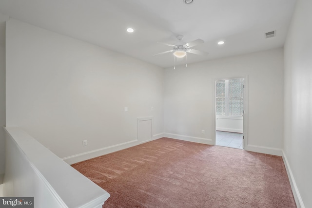 empty room with ceiling fan and light colored carpet