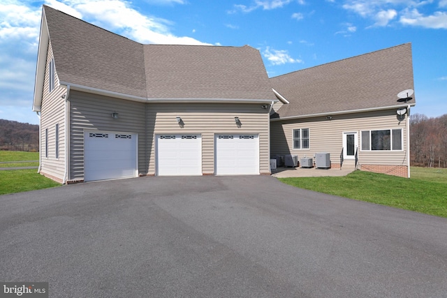 view of front of property with central AC unit and a front yard