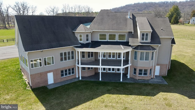 back of property with a patio and a yard