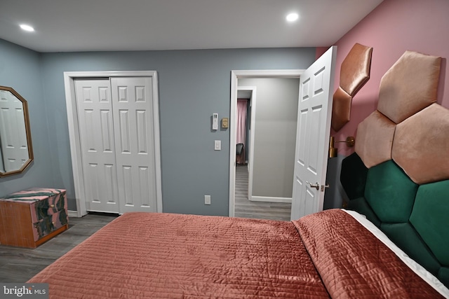 bedroom featuring dark hardwood / wood-style floors and a closet