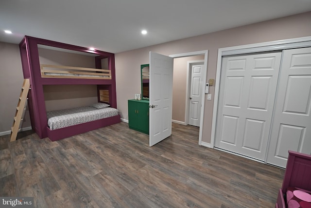 bedroom with a closet and dark hardwood / wood-style floors