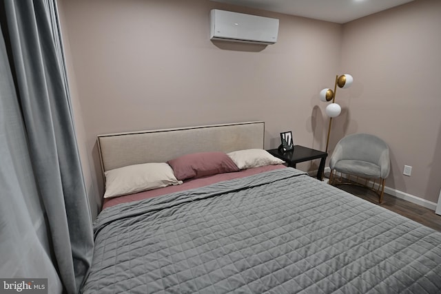 bedroom with dark wood-type flooring and an AC wall unit