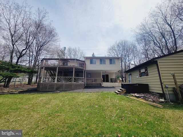 rear view of house featuring a yard and a deck