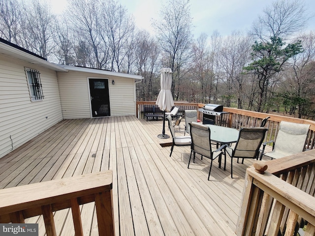 wooden deck featuring a grill