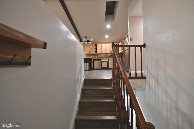 stairs featuring hardwood / wood-style floors