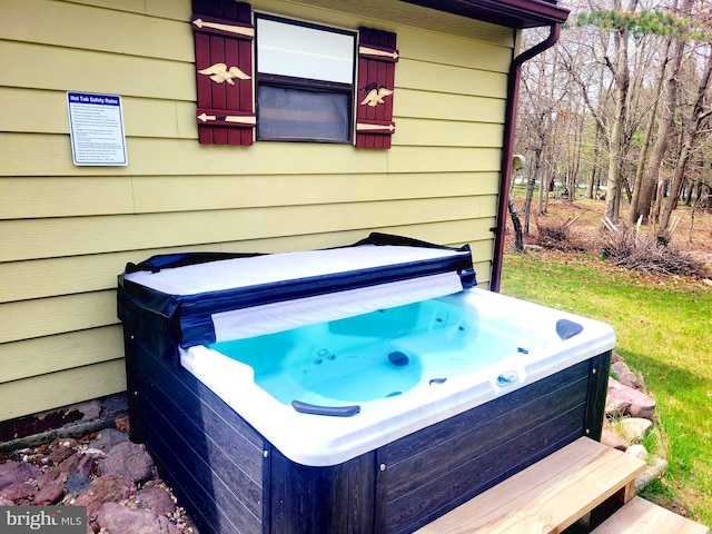 exterior space with a jacuzzi and wooden walls