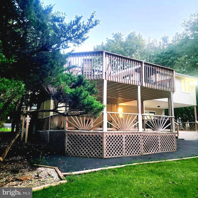 rear view of property with a wooden deck