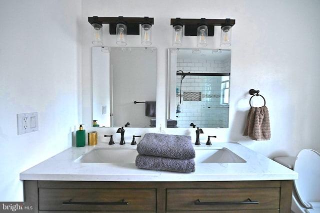 bathroom with vanity, toilet, and walk in shower