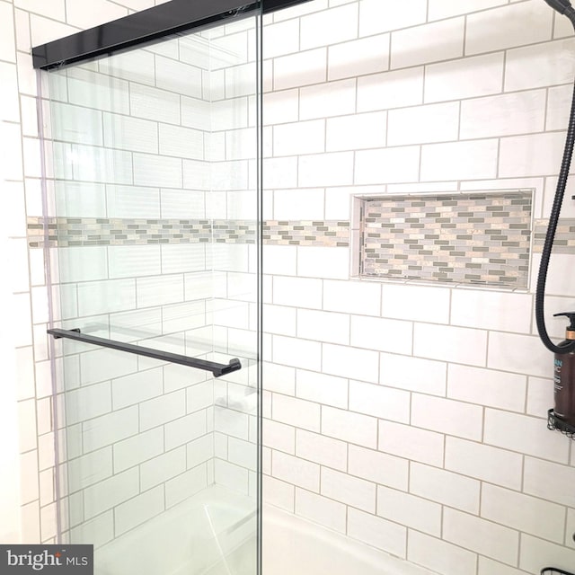 bathroom featuring a shower with shower door