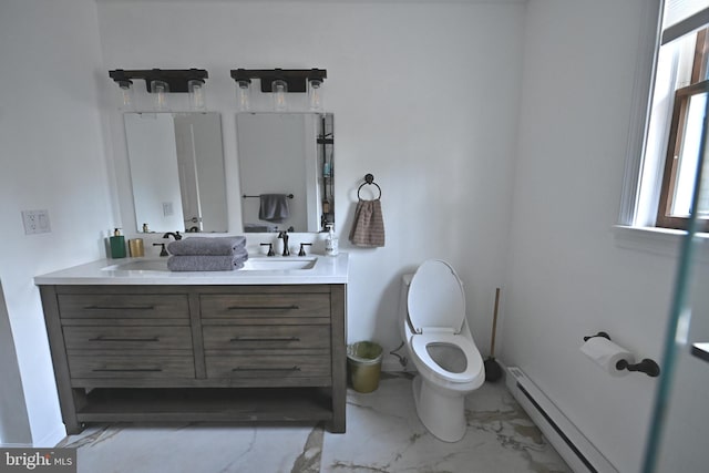 bathroom with a baseboard heating unit, vanity, and toilet