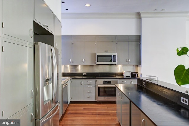 kitchen featuring gray cabinetry, dark hardwood / wood-style floors, and stainless steel appliances