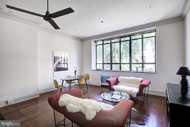 living room with dark hardwood / wood-style flooring, ceiling fan, and ornamental molding