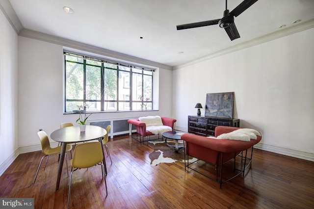 living area with ceiling fan, dark hardwood / wood-style floors, and crown molding