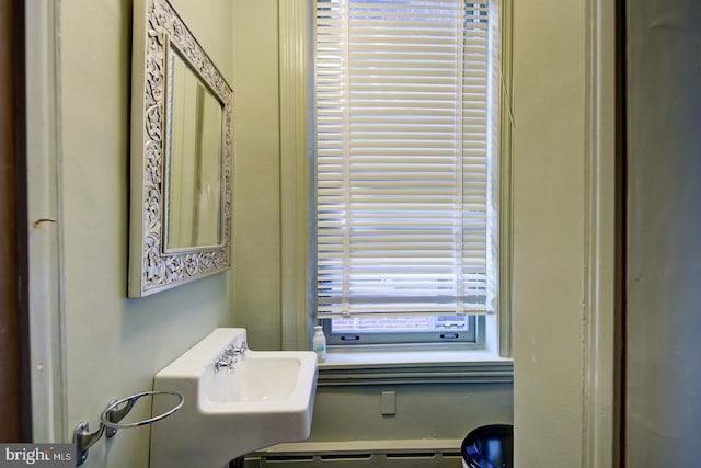 bathroom with a baseboard radiator and sink