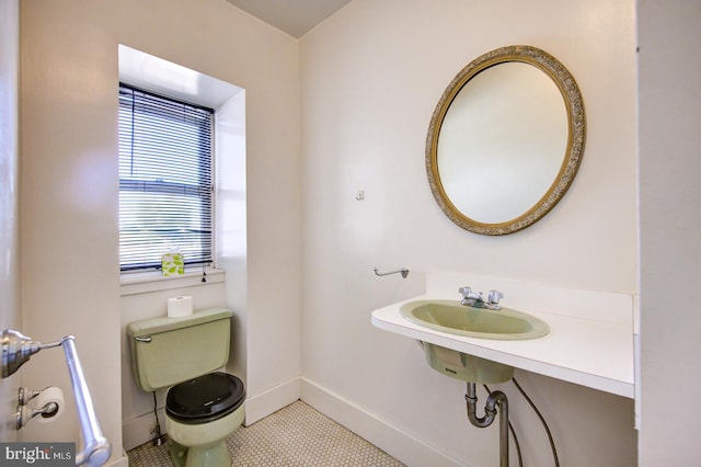 bathroom featuring toilet and tile floors