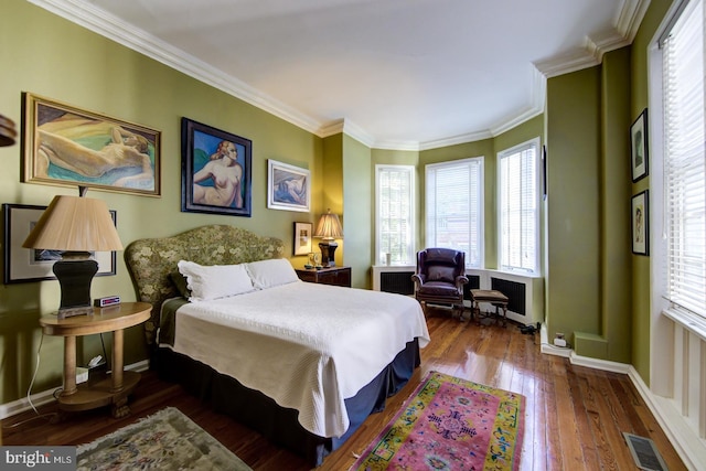 bedroom featuring ornamental molding, radiator, and dark hardwood / wood-style flooring