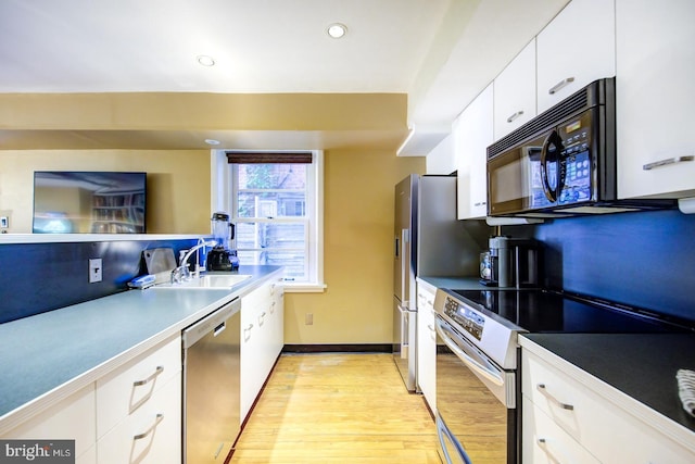 kitchen featuring white cabinets, light hardwood / wood-style flooring, sink, and stainless steel appliances