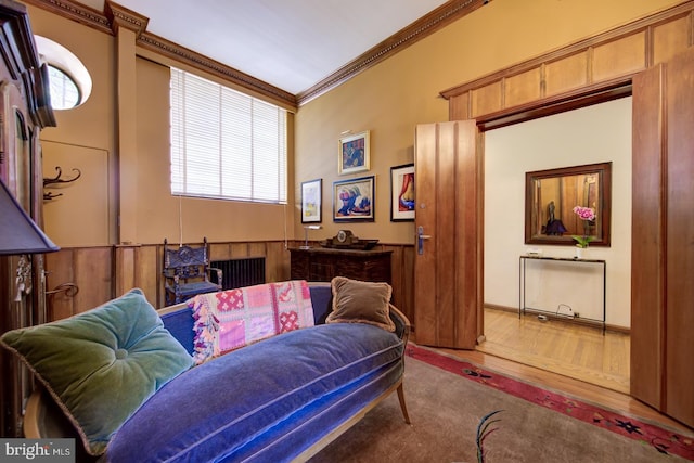 interior space with ornamental molding and light hardwood / wood-style flooring