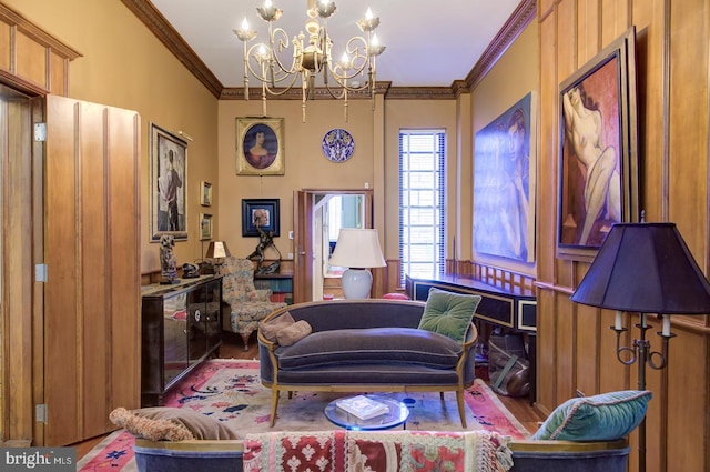 living room with a chandelier, hardwood / wood-style flooring, and ornamental molding