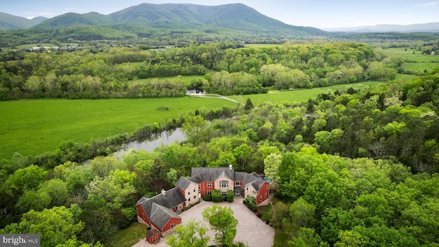 drone / aerial view featuring a water and mountain view