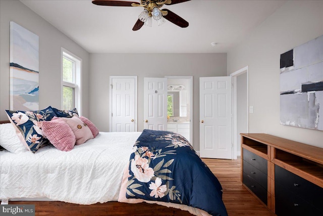 bedroom with ceiling fan, hardwood / wood-style floors, and connected bathroom