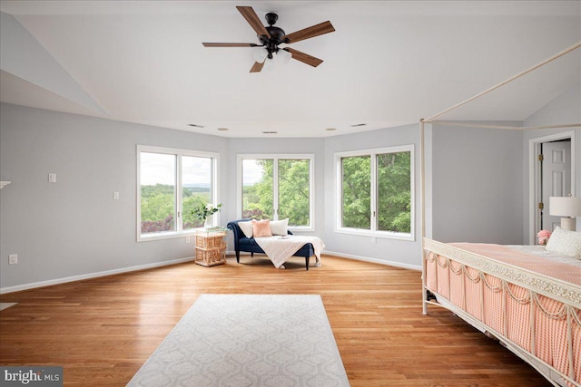 bedroom featuring lofted ceiling, light wood-type flooring, and ceiling fan
