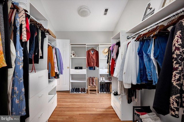 spacious closet featuring light hardwood / wood-style floors