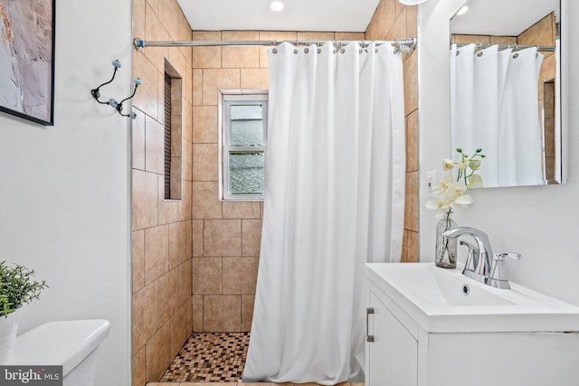 bathroom with vanity, curtained shower, and toilet