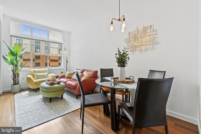 dining area with a notable chandelier and wood-type flooring