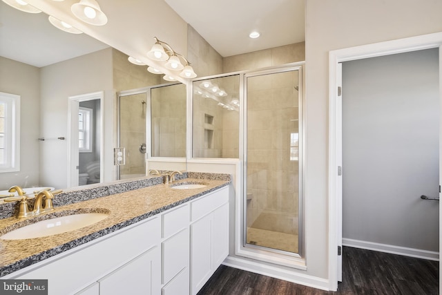 bathroom featuring an enclosed shower, vanity, and hardwood / wood-style flooring