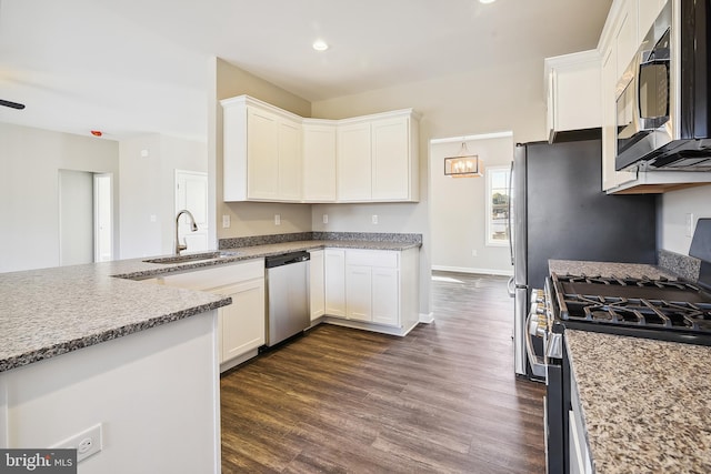 kitchen with appliances with stainless steel finishes, light stone countertops, dark hardwood / wood-style flooring, white cabinets, and sink