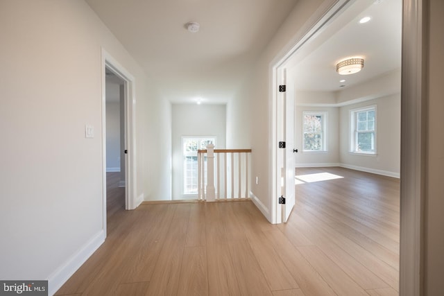 hallway with light hardwood / wood-style floors