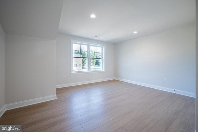 spare room with light hardwood / wood-style floors