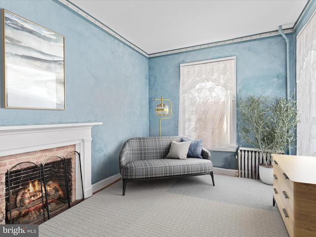 sitting room featuring ornamental molding, light carpet, and a fireplace