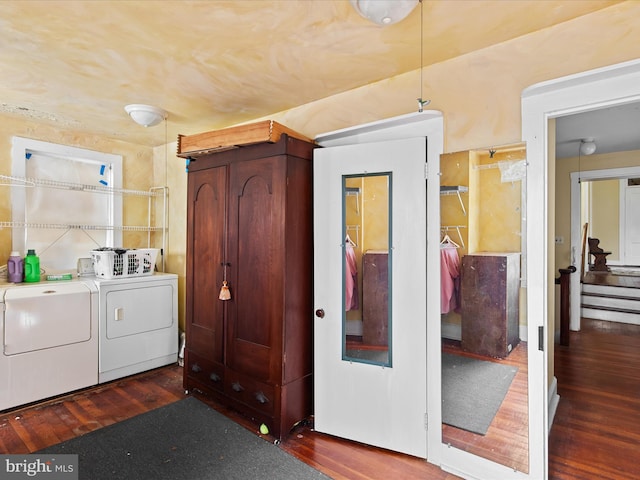 clothes washing area featuring washing machine and dryer and dark hardwood / wood-style flooring