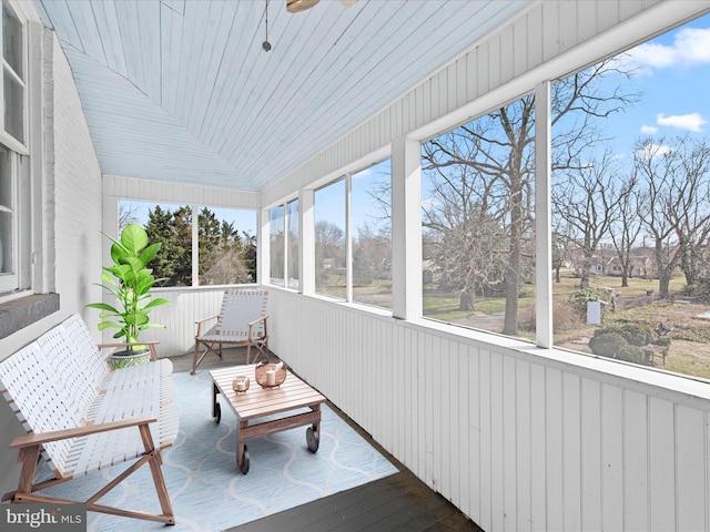 unfurnished sunroom with ceiling fan and wood ceiling