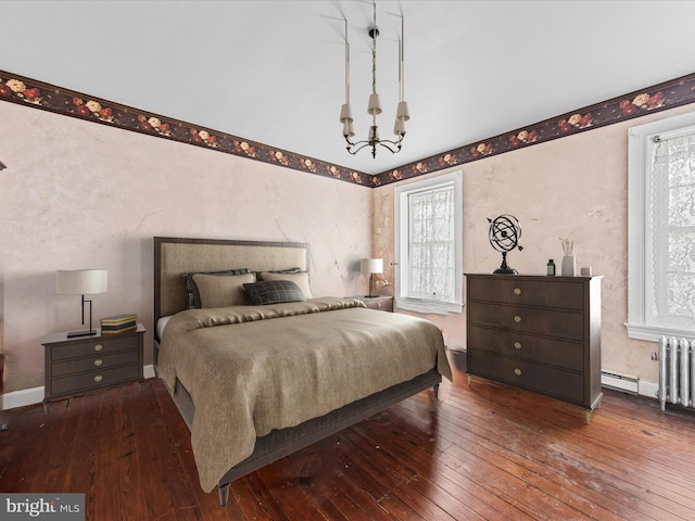 bedroom featuring a notable chandelier, dark hardwood / wood-style floors, and radiator