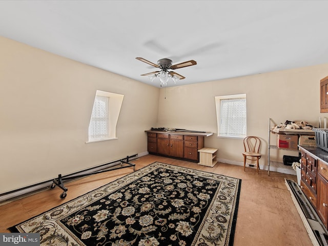 sitting room featuring baseboard heating, light hardwood / wood-style floors, and ceiling fan