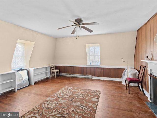 sitting room with a baseboard radiator, hardwood / wood-style floors, and ceiling fan